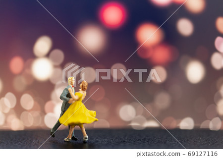 Miniature people , Couple dancing with bokeh background Miniature people , Couple dancing with bokeh background 69127116