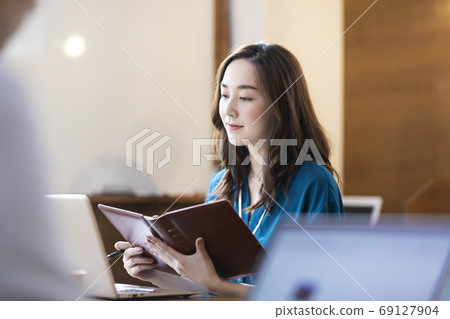A notebook for a woman working on a computer A notebook for a woman working on a computer 69127904