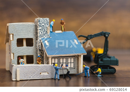 Miniature people: Workers team painting a new home. Renovation concept. Miniature people: Workers team painting a new home. Renovation concept. 69128014