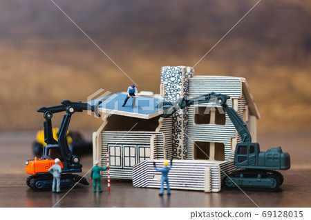 Miniature people: Workers team painting a new home. Renovation concept. 69128015