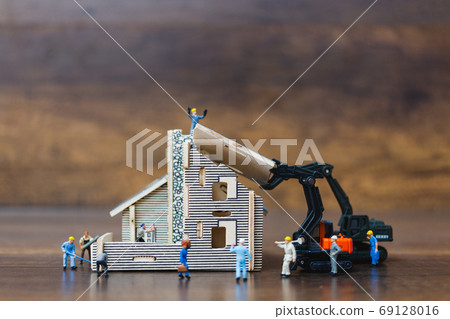 Miniature people: Workers team painting a new home. Renovation concept. Miniature people: Workers team painting a new home. Renovation concept. 69128016