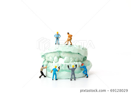 Miniature people : Worker team repairing a tooth ,Healthcare and medical concept Miniature people : Worker team repairing a tooth ,Healthcare and medical concept 69128029