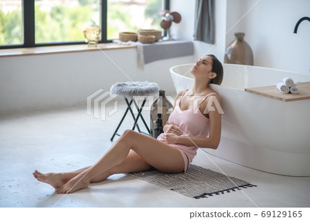 Young woman suffering from a menstrual pain 69129165