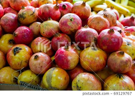 Fresh pomegranates in cardboard boxes Fresh pomegranates in cardboard boxes 69129767