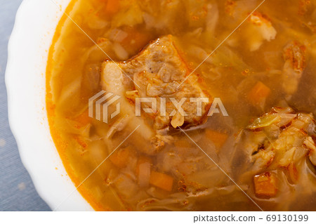 Soup of cabbage Shchi with pork and vegetables, served with sour cream Soup of cabbage Shchi with pork and vegetables, served with sour cream 69130199