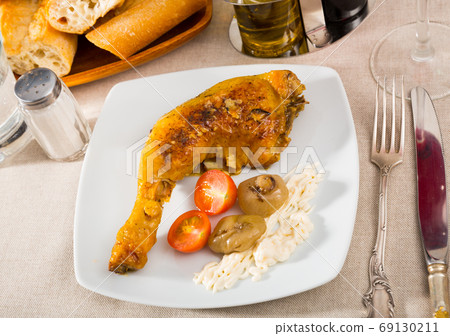 Roasted chicken leg quarter with baked onions and sauce Roasted chicken leg quarter with baked onions and sauce 69130211