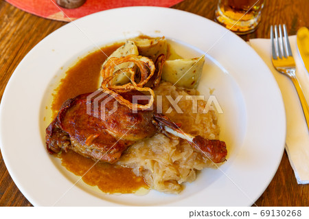 Confit duck leg with sauerkraut and dumplings Confit duck leg with sauerkraut and dumplings 69130268