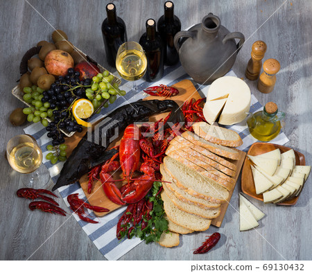 Still life with cooking seafood, wine, cheese and bread 69130432