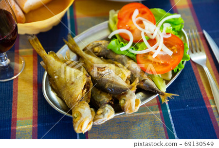 Appetizing fried fish scad. Spanish dish Appetizing fried fish scad. Spanish dish 69130549