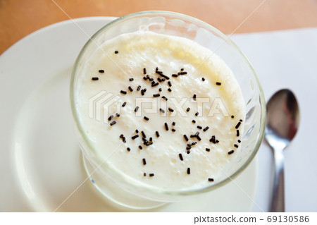 Sweet white homemade pudding served at plate with spoon 69130586