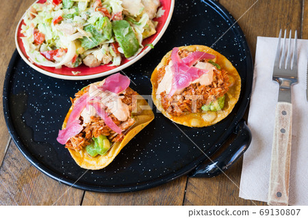 Mexican food, salad with chicken, avocado and tuna tostada 69130807