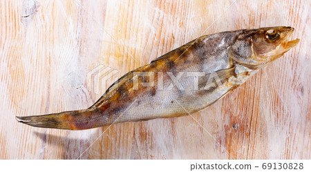 Whole dried salted pikeperch fish on wooden background. Beer snack Whole dried salted pikeperch fish on wooden background. Beer snack 69130828