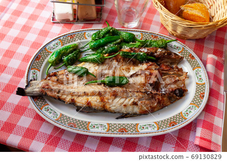 Grilled sea bass with peppers Grilled sea bass with peppers 69130829