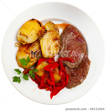 Tasty veal baked with potatoes and peppers served at plate Tasty veal baked with potatoes and peppers served at plate 69131004