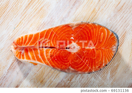 Raw salmon fillet on wooden table Raw salmon fillet on wooden table 69131136