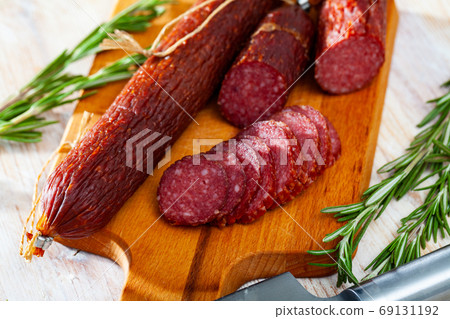 Raw smoked salami with fresh rosemary Raw smoked salami with fresh rosemary 69131192
