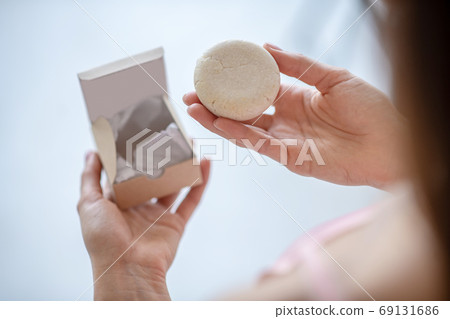 Woman trying a new scrabing soap product Woman trying a new scrabing soap product 69131686