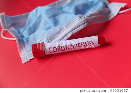 blood test tube and mask on red backgrund blood test tube and mask on red backgrund 69131687