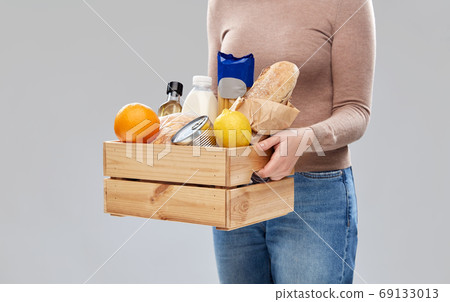 close up of woman with food in wooden box close up of woman with food in wooden box 69133013