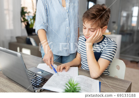 mother and son doing homework together mother and son doing homework together 69133188