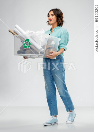happy smiling young woman sorting paper waste 69133202