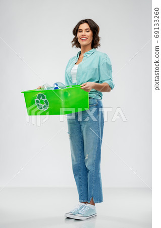 smiling young woman sorting plastic waste 69133260
