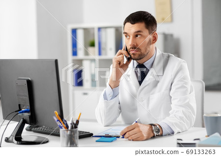 male doctor calling on phone at hospital 69133263