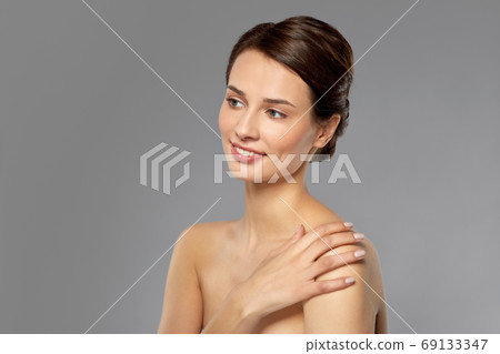 beautiful young woman touching bare shoulder 69133347