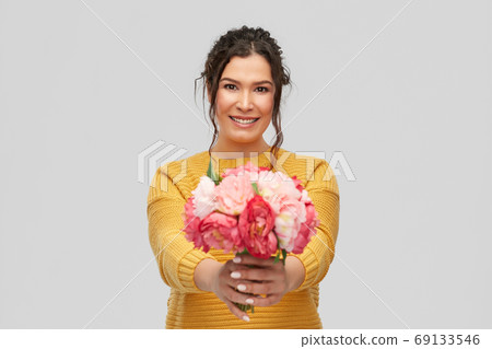 happy smiling young woman with bunch of flowers happy smiling young woman with bunch of flowers 69133546