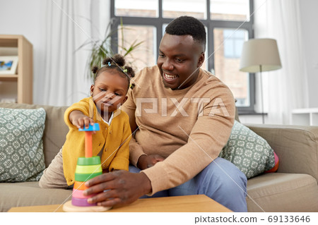 african family playing with baby daughter at home african family playing with baby daughter at home 69133646