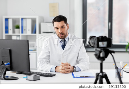 male doctor with recording video blog at hospital male doctor with recording video blog at hospital 69133800