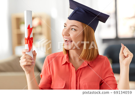 student woman with laptop and diploma at home 69134059