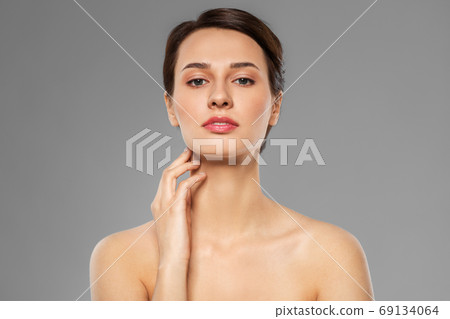 beautiful young woman touching her neck beautiful young woman touching her neck 69134064