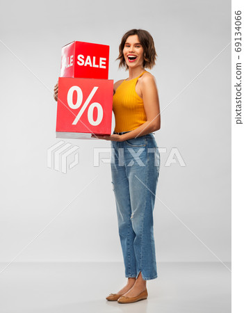 happy smiling young woman with sale signs 69134066