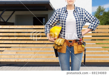 woman or builder with helmet and working tools woman or builder with helmet and working tools 69134069