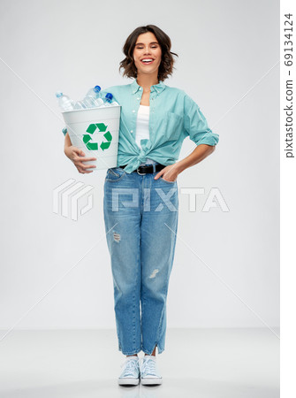 smiling young woman sorting plastic waste smiling young woman sorting plastic waste 69134124