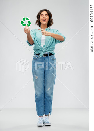 smiling young woman holding green recycling sign smiling young woman holding green recycling sign 69134125
