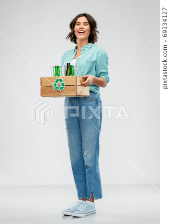 smiling young woman sorting glass waste 69134127