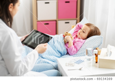 doctor with tablet computer and sick girl in bed doctor with tablet computer and sick girl in bed 69134169