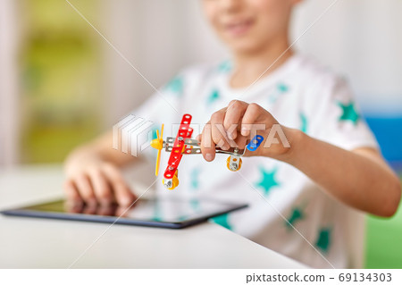 happy little boy playing with airplane toy at home happy little boy playing with airplane toy at home 69134303