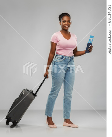 happy young woman with air ticket and travel bag happy young woman with air ticket and travel bag 69134353