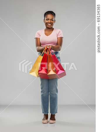 happy african american woman with shopping bags happy african american woman with shopping bags 69134365