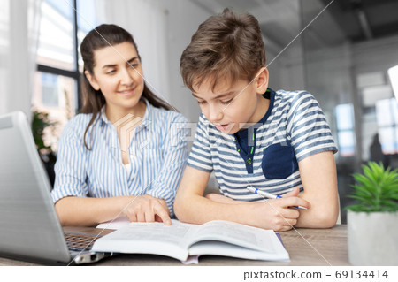 mother and son doing homework together mother and son doing homework together 69134414