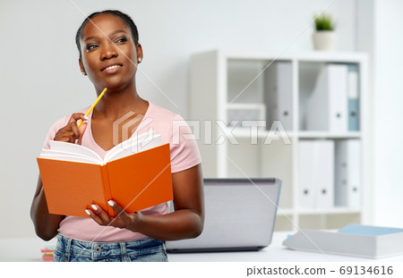 african american woman with notebook at office african american woman with notebook at office 69134616