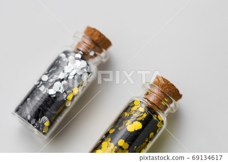 silver and gold glitter in bottles on white silver and gold glitter in bottles on white 69134617