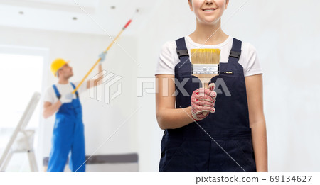 close up of painter or builder with paint brush close up of painter or builder with paint brush 69134627