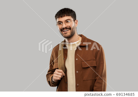 smiling young man in glasses with backpack smiling young man in glasses with backpack 69134685