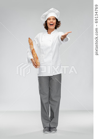 happy female chef with french bread or baguette happy female chef with french bread or baguette 69134769