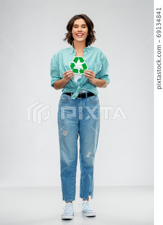 smiling young woman holding green recycling sign 69134841