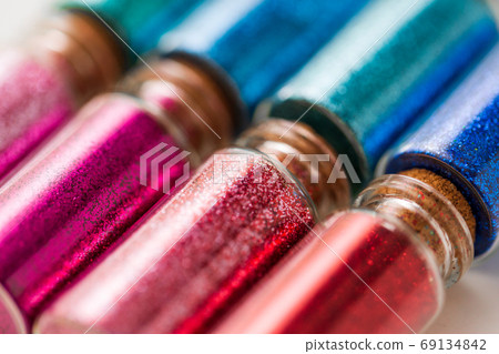 set of different glitters in small glass bottles 69134842